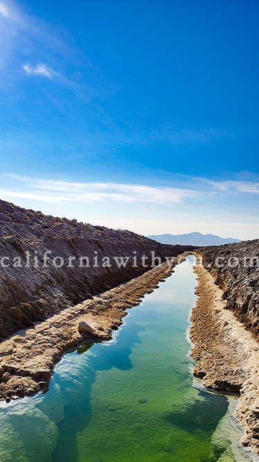 Amboy Salt flat, chlorine pool, salt mining canal in Mojave Desert in California.